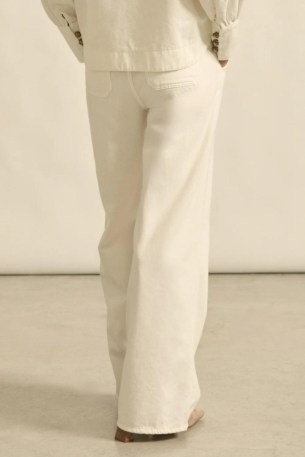 Beige pants worn by a person on a neutral background